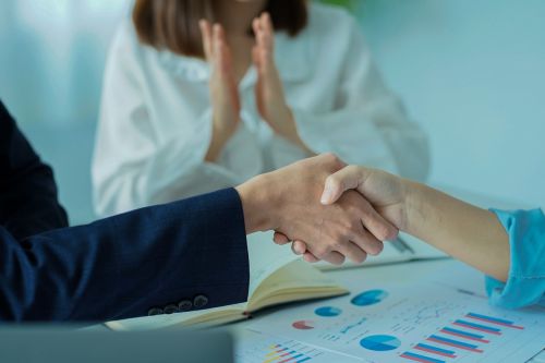 Good deal. Businessmen shake hands. With colleagues agree to do business together. goal achievement and expand the online digital commerce market around the world immediately
