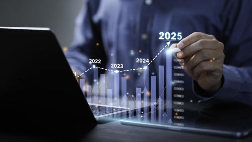 Businessman analyzes the graph of trend market growth in 2025 and plans business growth and profit increase in the year 2025. plan finances of the business