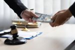 Business people shaking hands and bribe to an attorney to help a lawyer win a court case. The concept of bribing lawyers and paying lawsuits.